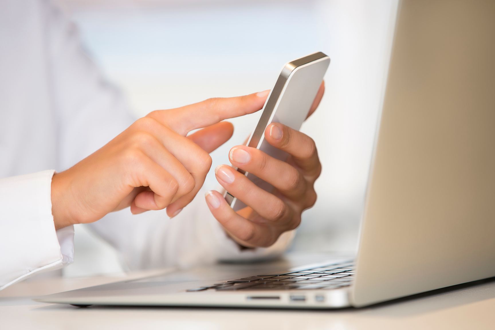 Female hands working on the computer, cell phone